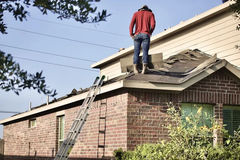 Professional roofer working on a residential roof in Cedonia